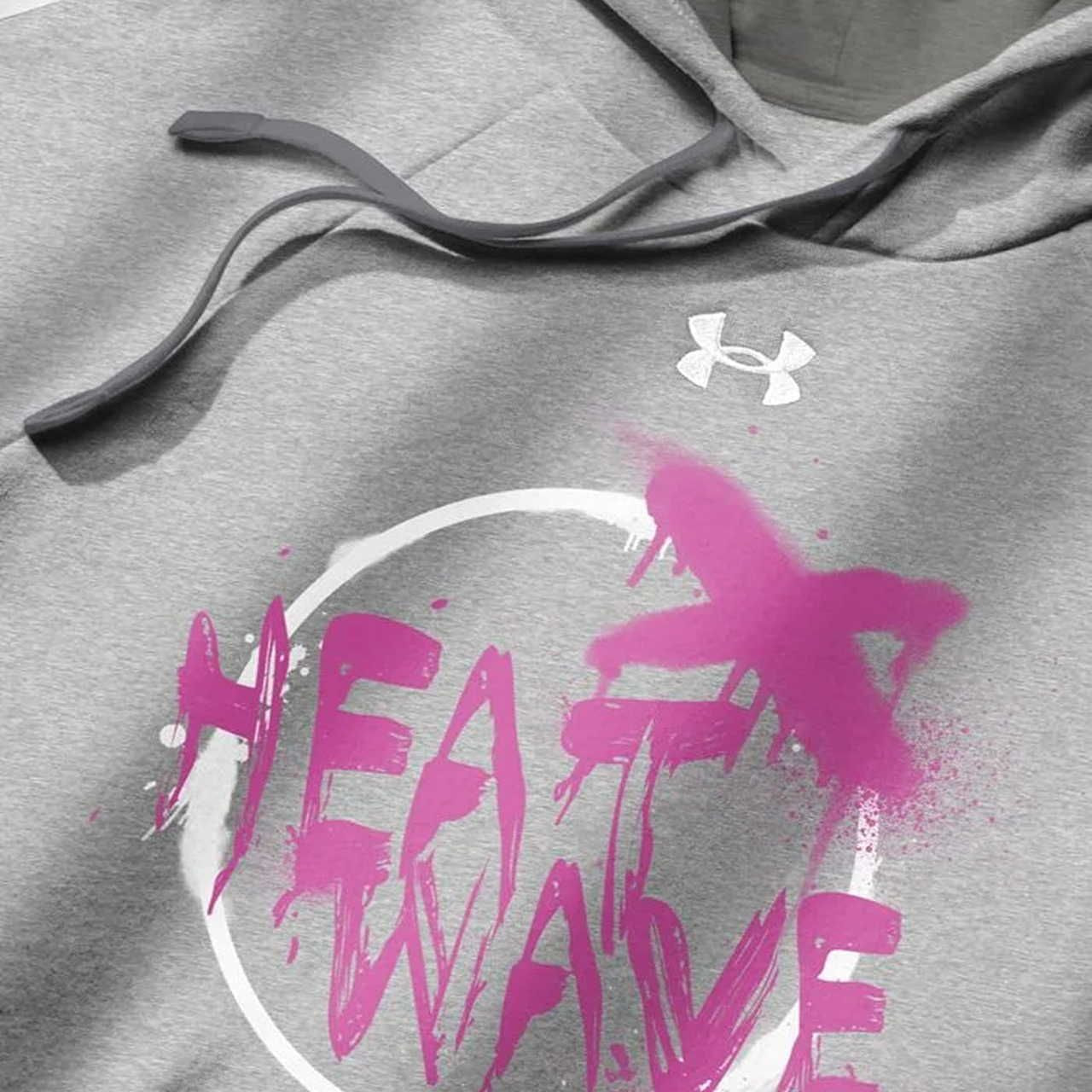 Gray hoodie with a white logo near the neck. "HEAT WAVE" in bold pink graffiti-style text is on the front, partially covered by pink spray paint.